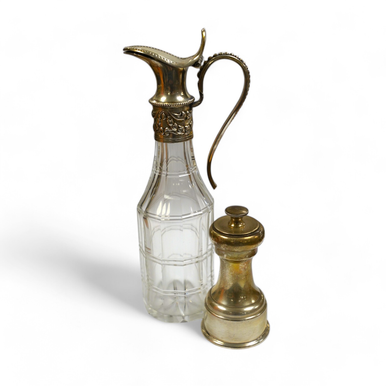 A modern silver mounted pepper mill, London, 1973, 86mm and a Victorian silver mounted glass vinegar bottle. Condition - poor to fair